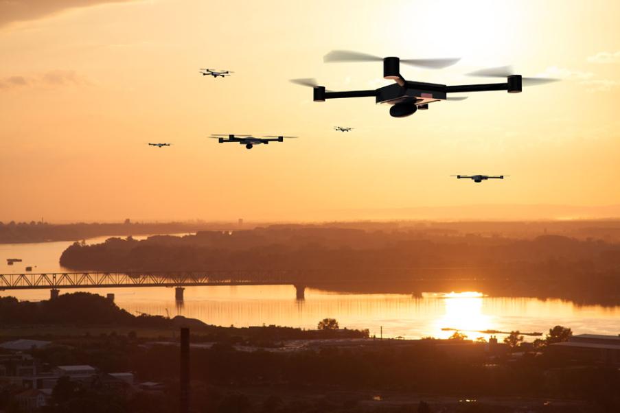 Drones flying at sunset